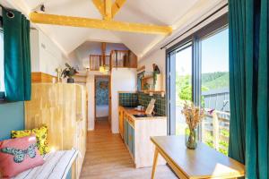 a tiny house with a kitchen and a living room at Tiny house Kapha in Les Alliés