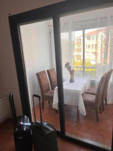 a dining room with a table and chairs and a window at Appartement cosy à Fréjus, 26 m² avec piscine in Fréjus