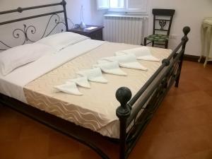 a bed with white pillows on top of it at Antica Dimora in Orbetello