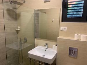 a bathroom with a sink and a glass shower at REZEVICI BOUTIQUE VILLA in Petrovac na Moru