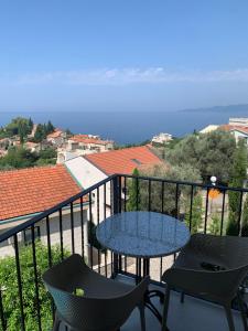 a patio with a table and chairs on a balcony at REZEVICI BOUTIQUE VILLA in Petrovac na Moru