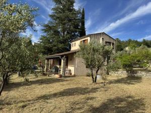 a house with trees in front of it at L'oliveraie in Correns