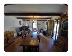 a living room with a dining room table and chairs at L'oliveraie in Correns