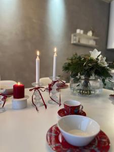 a table with candles and cups on a table at Arctic Riverside Villa in Rovaniemi +23 photos