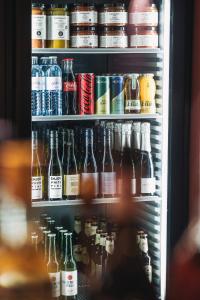 a refrigerator filled with lots of bottles of beer at Studio 17 Bregenz in Bregenz +30 photos