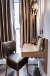 a desk with a chair next to a window at The Jade in London