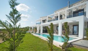 an exterior view of a house with a swimming pool at Sunrise Villas Collection in Polychrono
