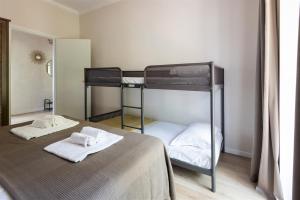 two bunk beds in a small room with white towels at IseoLakeRental - Casa Massimo in Lovere