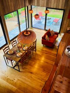 a dining room with a table and chairs in a house at La noisette in Florennes