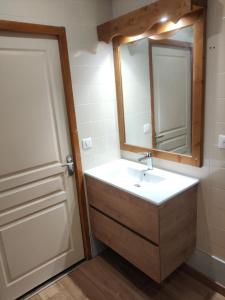 un baño con lavabo y espejo en V du Bachat Epicea A N24 2P6, en Chamrousse