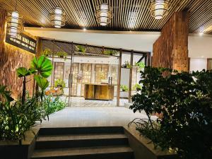 a lobby of a building with trees and plants at 302MSNK Luxe Studio w Balcony & Kitchen in Can Tho