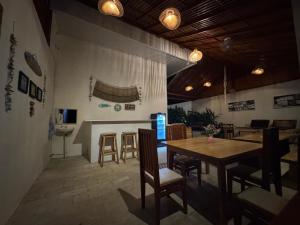 a dining room with a wooden table and chairs at mc villa bunaken in Bunaken