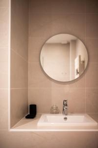 a bathroom with a sink and a mirror at App Marguerite - Villa Bon Accueil proche mer in Mers-les-Bains +26 photos
