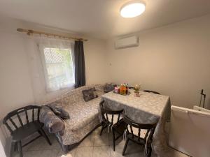a living room with a table and a couch at LídRind porta in Zalaszentgrót
