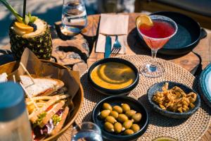 a table topped with bowls of food and a drink at Divino Caldera in Akrotiri