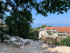 a group of chairs and a table on a patio at REZEVICI BOUTIQUE VILLA in Petrovac na Moru