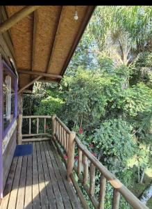 a porch of a house with a wooden deck at chalé Ateliê in Itatiaia