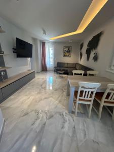 a living room with a table and a couch at H&H Rooms Rovinj - Adults Only in Rovinj +29 photos