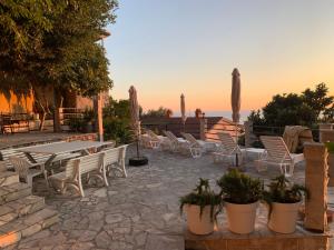 a patio with chairs and a table and a table and chairs at REZEVICI BOUTIQUE VILLA in Petrovac na Moru