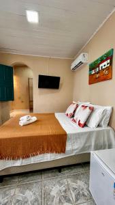 a bedroom with a large bed in a room at Suítes Benfica in Arraial d'Ajuda +43 photos