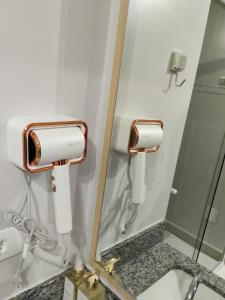 a mirror in a bathroom with a sink at Novo studio sofisticado ao lado do Allianz Parque in Sao Paulo