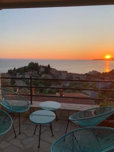 a patio with chairs and a view of the ocean at REZEVICI BOUTIQUE VILLA in Petrovac na Moru