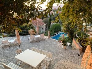 a patio with a white table and chairs at REZEVICI BOUTIQUE VILLA in Petrovac na Moru
