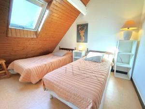 a bedroom with two beds and a window at T3 Duplex 6 Pers, Parking, Cuisine Équipée, Proche St Lary - FR-1-457-283 in Vielle-Aure +4 photos