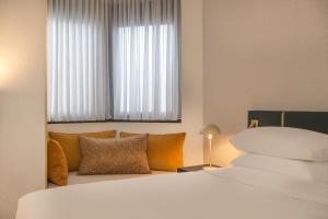a hotel room with a bed and a window at Hyatt Centric Reims in Reims