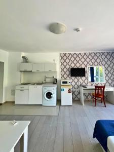a kitchen with a washing machine and a table at STELA in Nesebar