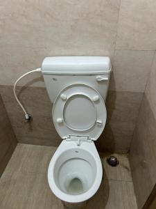 a bathroom with a toilet in a stall at Sri Lingaraja Temple Stay Budget Rooms & Dormitory in Old Town in Bhubaneshwar +15 photos
