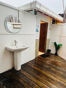a bathroom with a sink and a mirror at Seaweed Village Deluxe Room in Semporna