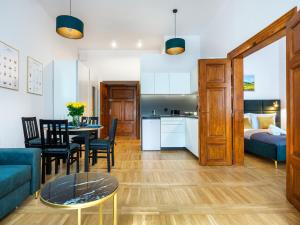 a living room with a couch and a table at Golden Market Square Apartments by Tyzenhauz in Kraków