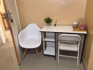 a desk with a chair and a table and a stool at Kalahari in Sekoma