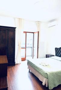a bedroom with a bed and a large window at Suite sogni di lago Lecco, Como in Malgrate