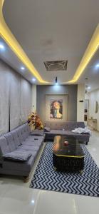 a living room with couches and a coffee table at Whispering heights in Murree