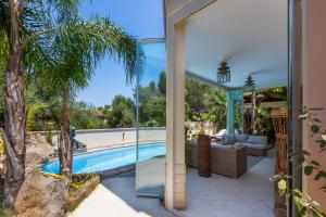 a house with a swimming pool and a patio at Stunning Villa Paola with Swimming Pool & Terrace! in Villasimius