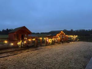 a row of houses with lights on a gravel road at Celebrating or Relaxing 5-star farm stay with spa and more! in Kirk of Shotts