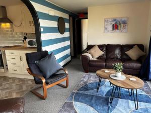 a living room with a couch and a table at Northfield Holiday Park in Borth