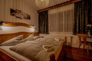 a bedroom with a large bed with a wooden frame at Landhaus Gaspar in Wagrain