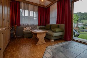 a living room with a couch and a table at Landhaus Gaspar in Wagrain