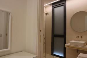 a bathroom with a shower and a sink and a mirror at Casa Rural La Tajuela in Bohonal de Ibor