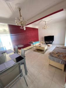 a living room with a couch and a table at La belle vue in Bologuine Ibnou Ziri