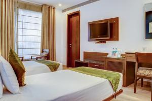 Postel nebo postele na pokoji v ubytování Amber Inn by Orion Hotels