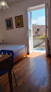 a bedroom with a bed and a door to a balcony at Casa storica di Sant'Andrea by Italita in Calamandrana