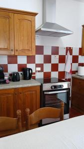 a kitchen with red and white checkered wall at Casa storica di Sant'Andrea by Italita in Calamandrana +19 photos