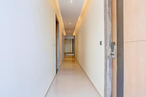 an empty hallway with a hallway leading into a room at Super Townhouse ISBT Dehradun in Dehradun