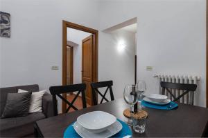 a dining room table with plates and wine glasses at Pallottole Duomo Apartments in Florence +86 photos