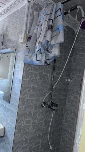 a room with a bed with a hose on the floor at Tina Villa in Nairobi