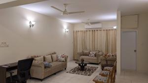 a living room with a couch and a table at Room in Uttara Sector 3 Apartment in Bāiljuri